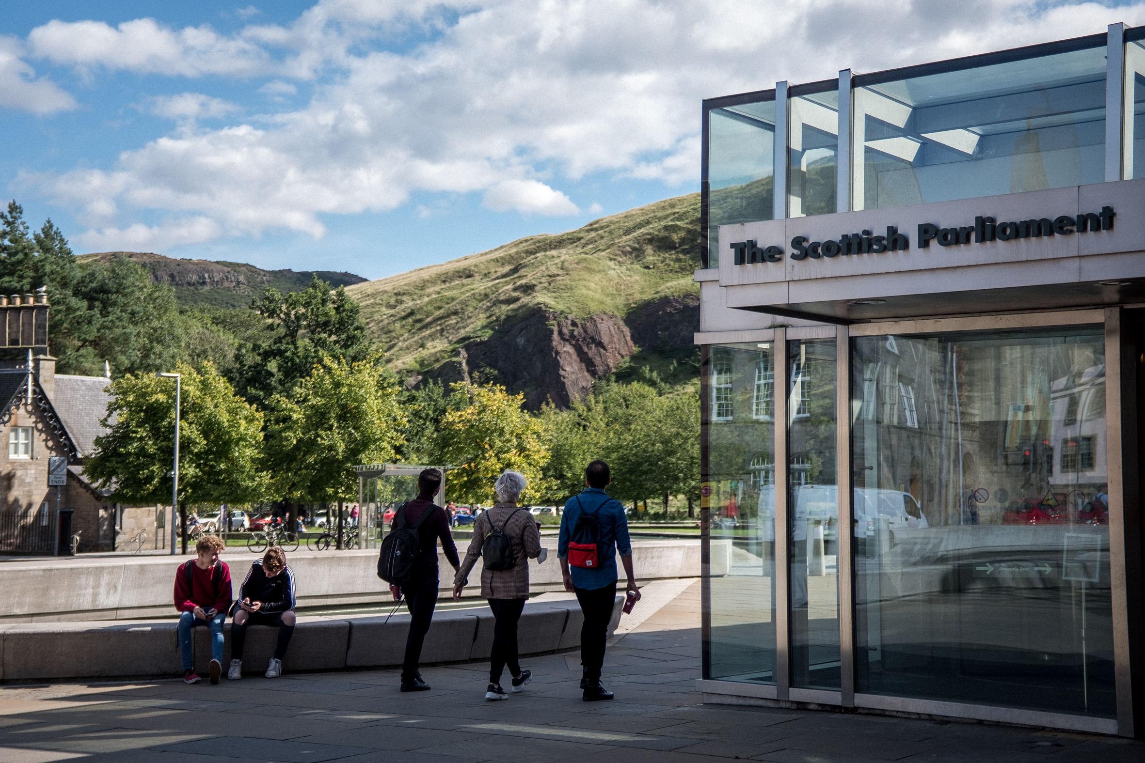 People walking by the Scottish Parliament building in Edinburgh.
