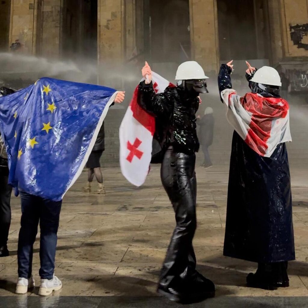 Demonstrators being targeted by police water cannon in front of the Parliament, in Tbilisi, December 2024. | Photo: ©Masho Lomashvili