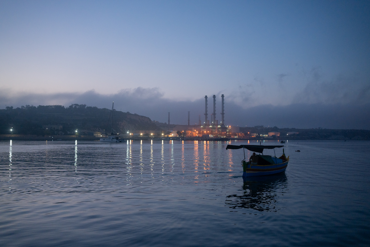 A fisherman sets out to sea before dawn on his luzzu in the bay of Marsaxlokk, Malta. | Photo: ©Bruna Cases/RUIDO